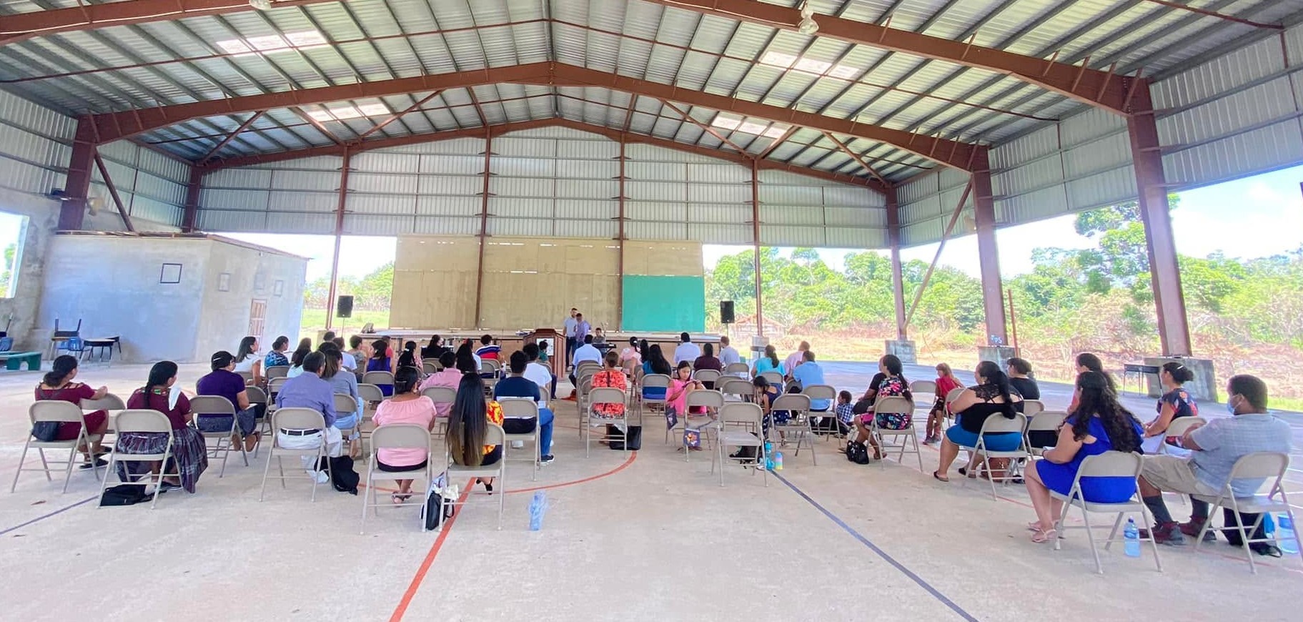 Church family gathered under the pavilion during a community support gathering
