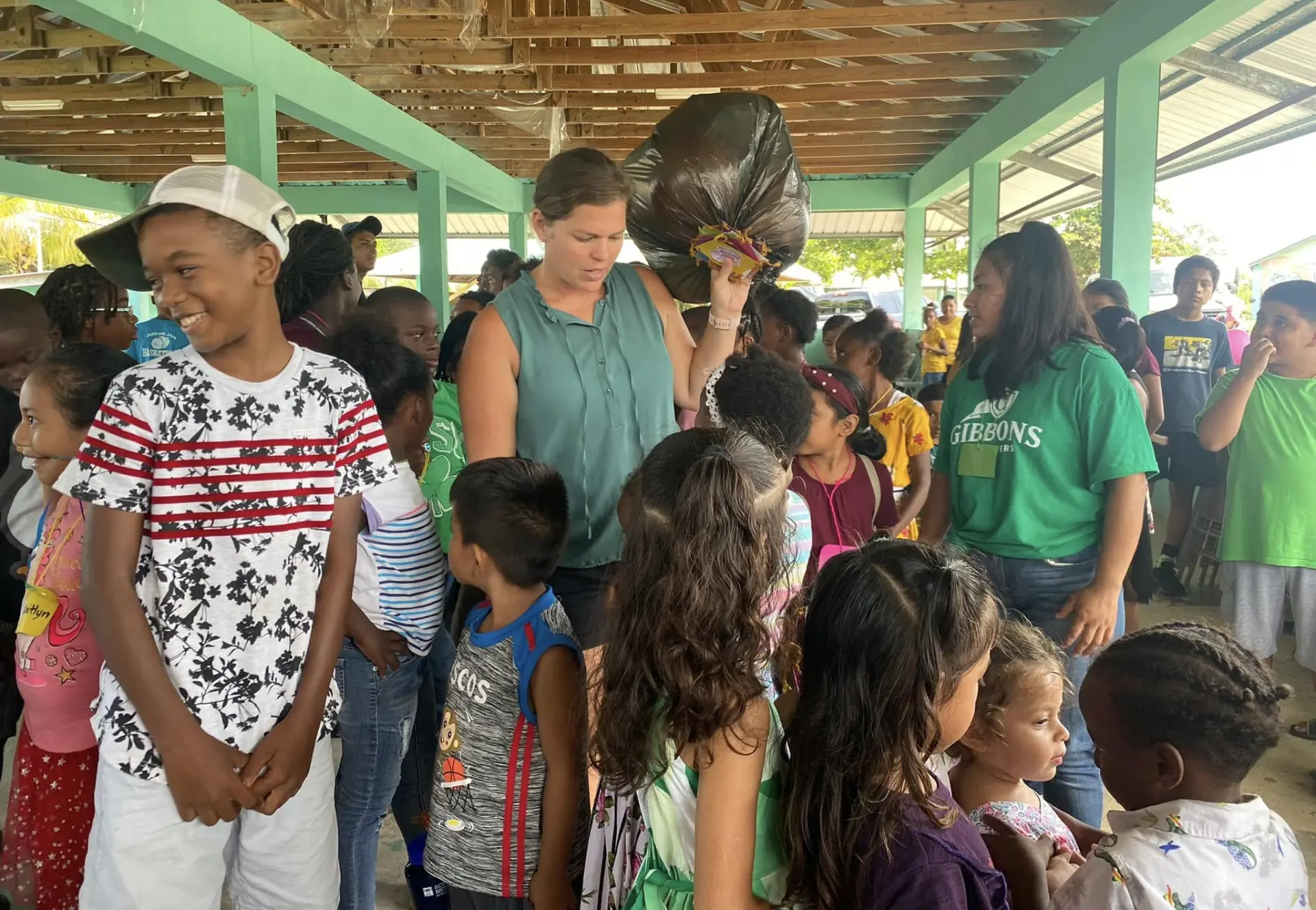 Church volunteer handing out gift bags to children at an outreach