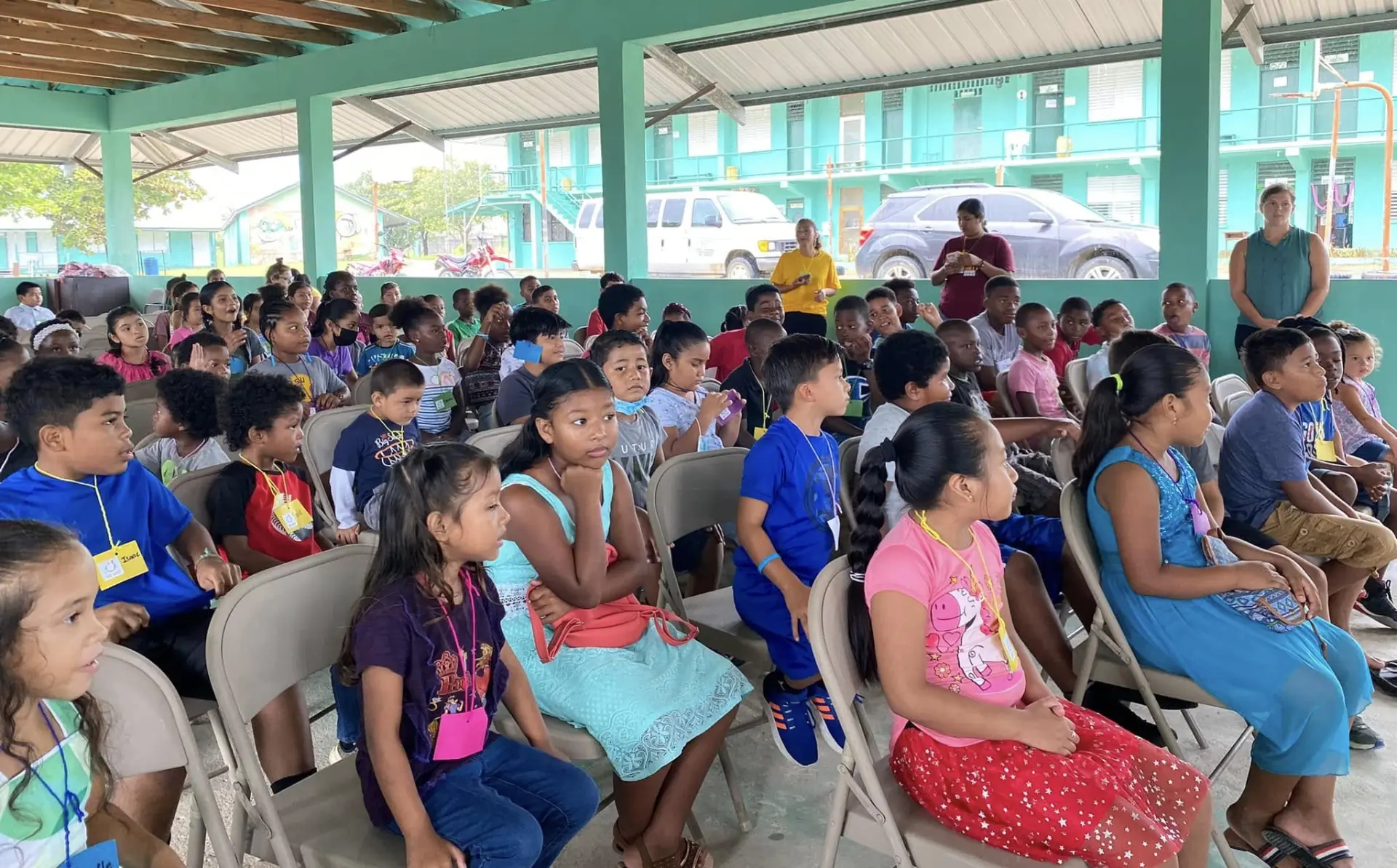 Children seated together during a kids camp session in Belize