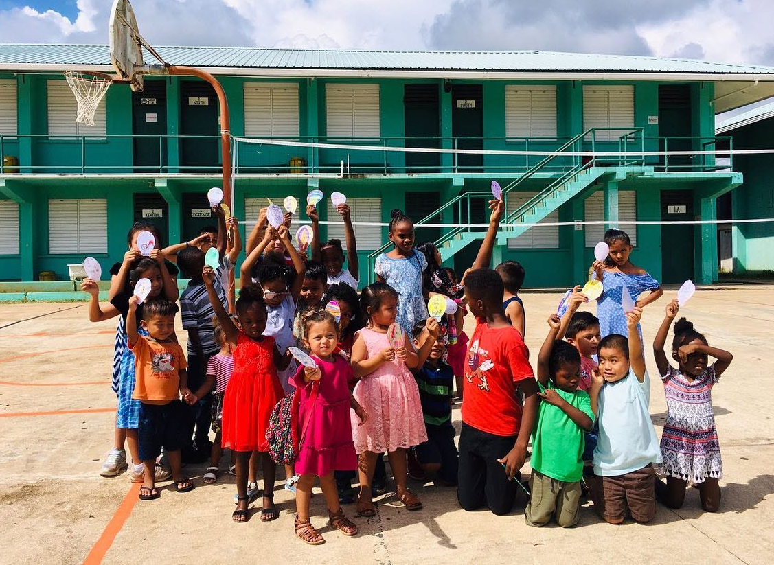 Children holding up their craft projects after a kids program